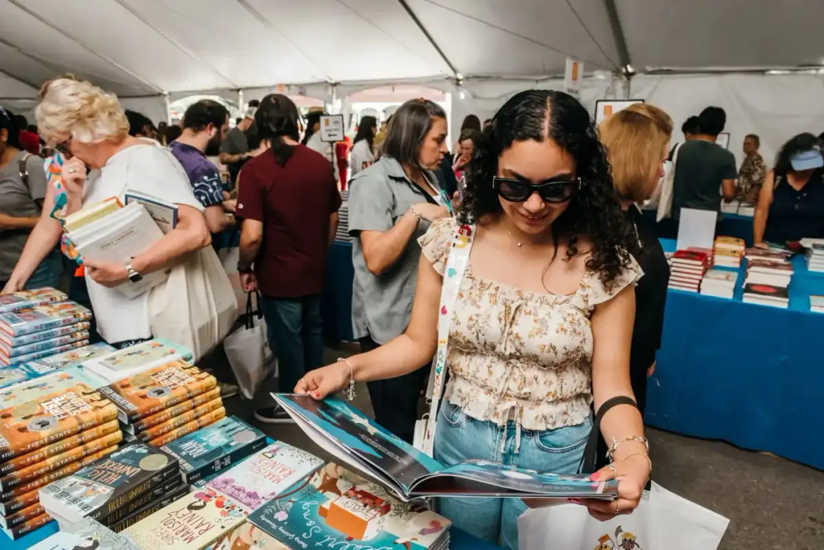 Reader discovering a book at a fair booth